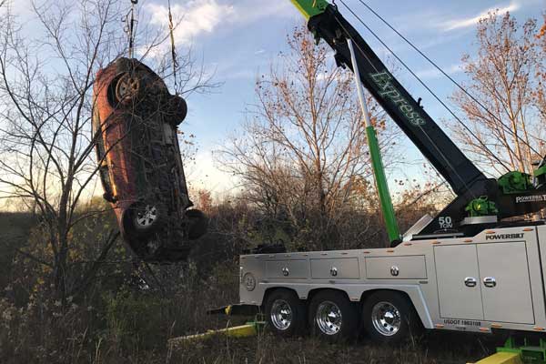 Crane Lifting Car Out of Trees